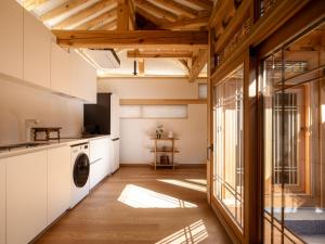 a kitchen with a washer and dryer in a room at Luxury Hanok On169 in Seoul