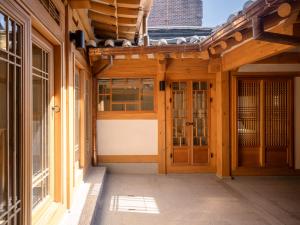 a porch of a building with wooden doors at Luxury Hanok On169 in Seoul +4 photos