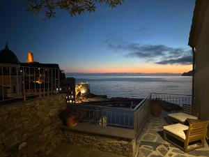 a view of the ocean at sunset from a balcony at Il Conventino delle Cinque Terre - Sea View - AC&WiFi - Vernazzarentals in Vernazza