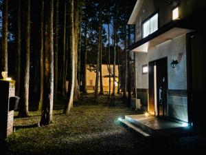 a house with lights on the side of it at night at 晴川-箱根Hotel-KA0575 in Sengokuhara