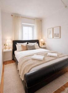 a bedroom with a large bed with two pillows on it at Apartment 3 Sea Centrum Stavanger in Stavanger