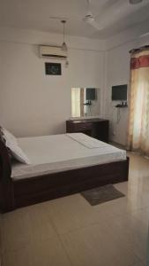 a bedroom with a large bed in a room at Pearl City Resort in Tissamaharama