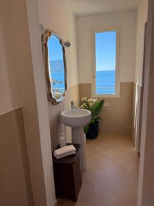 a bathroom with a sink and a mirror at Il Conventino delle Cinque Terre - Sea View - AC&WiFi - Vernazzarentals in Vernazza +42 photos