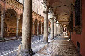 an arcade of a building with columns and ceilings at Lu.Lu Suite and Rooms in Piacenza