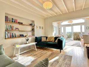 a living room with a green couch and a table at Cottage 498 - Cleggan in Cleggan