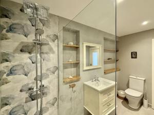 a bathroom with a shower and a toilet and a sink at Cottage 498 - Cleggan in Cleggan +32 photos