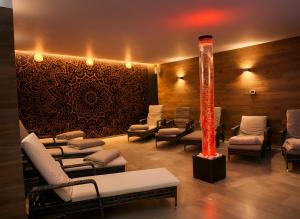 a salon with a waiting room with chairs and a pole at Lázeňský hotel Pyramida in Františkovy Lázně