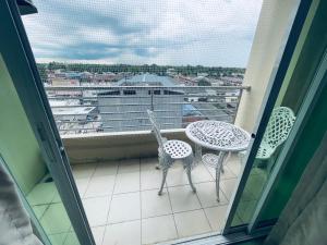 a balcony with a table and chairs and a view of a ship at เพียร์93 in Ban Pak Khlong Si