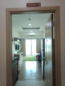 a hallway with a door open to a living room at เพียร์93 in Ban Pak Khlong Si