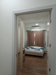 a bedroom with a bed and a large mirror at เพียร์93 in Ban Pak Khlong Si