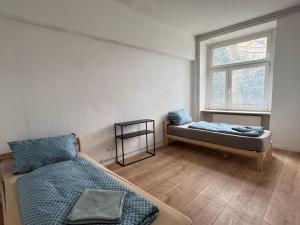 a bedroom with two beds and a window at Platin Appartement in Wuppertal