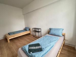 a bedroom with a bed and a bench in it at Platin Appartement in Wuppertal +1 photo