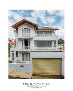 a white house with a yellow garage at Green Royal Villa in Kandy