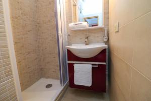 a small bathroom with a sink and a shower at Kyma's House in Otranto in Otranto +19 photos