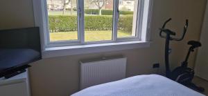 a bedroom with a window and two vacuum cleaners at Double room in rosyth in Rosyth