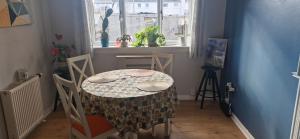 a table and chairs in a room with a window at Double room in rosyth in Rosyth
