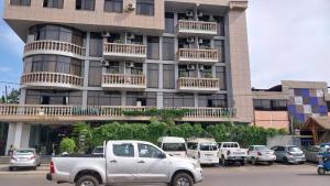 a white truck parked in front of a building at Fidel Hotel in Bahir Dar