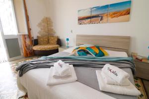 a bedroom with a bed with two towels on it at Kyma's House in Otranto in Otranto