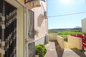 a door to a building with a view of a field at Kyma's House in Otranto in Otranto