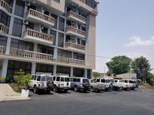 a row of cars parked in front of a building at Fidel Hotel in Bahir Dar
