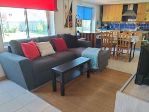 a living room with a couch and a table at A Finquiña in Salcidos