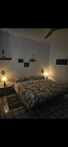 a bedroom with a large bed and two lamps at A casa di Ale in Stromboli