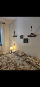 a bedroom with a large bed and a lamp at A casa di Ale in Stromboli +5 photos