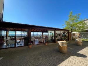 a building with a lot of windows and tables at Albergo Diffuso Belvedere in Alice Bel Colle