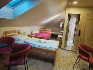 a room with two beds and a table and chairs at Hotel Taurus in Ostrava +144 photos