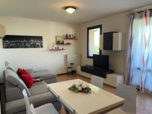 a living room with a couch and a table at Marina Fiorita in Grado
