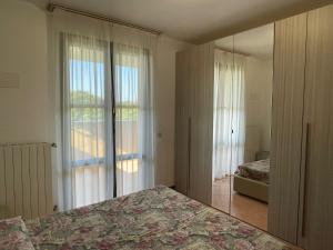 a bedroom with a bed and a large window at Marina Fiorita in Grado +21 photos