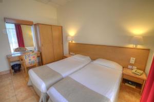 Postel nebo postele na pokoji v ubytování Allegro Hotel