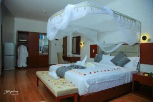 a bedroom with a large white bed with a canopy at Fidel Hotel in Bahir Dar