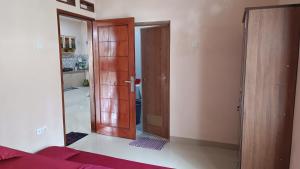a room with a wooden door and a mirror at Villa 4 Kamar Tidur Dengan Kolam Renang Pribadi in Puncak +15 photos