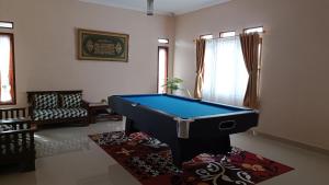 a living room with a pool table in it at Villa 4 Kamar Tidur Dengan Kolam Renang Pribadi in Puncak