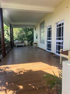 an empty porch of a house with a wooden floor at Yugm Homes Rishikesh in Narendranagar