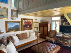 a living room with a couch and a tv at Villa Panorama in Symi