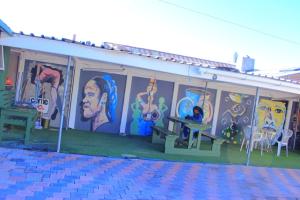 a building with a mural on the side of it at Inspan Home & Lodge in Bellville South