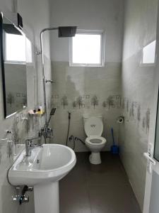 a bathroom with a sink and a toilet at Kandy Alpine Breeze in Kandy