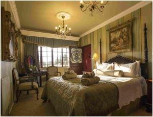 a bedroom with a bed with three pillows on it at De Ark Guest House in Lydenburg +50 photos