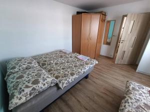 a bedroom with a bed and a wooden floor at Dům u Skašků - Žabeň in Žabeň