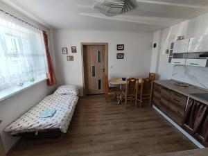 a small room with a bed and a table at Dům u Skašků - Žabeň in Žabeň