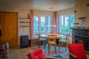 a living room with a table and chairs and windows at Casa Roccolo in Astano +16 photos