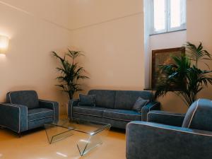 a living room with two blue couches and a table at Unconventional Sorrento Coast in Sant'Agnello