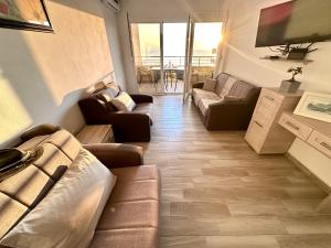 a living room with couches and a flat screen tv at Apart-Hotel Saraj in Dobra Voda