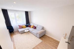 a living room with a couch and a window at ZB Apartment with Free Private Parking in Rēzekne