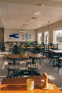 an empty restaurant with tables and chairs and tablesktop at Yttersia Base in Senja