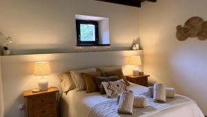 a bedroom with a bed with two lamps and a window at Casa PREGONDA in Isla +51 photos