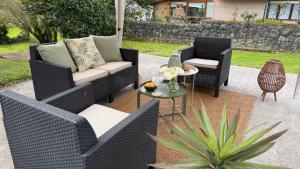 a patio with two chairs and a couch and a table at Casa PREGONDA in Isla