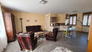 a living room with a couch and a table at La demeure Flieg in Cernay